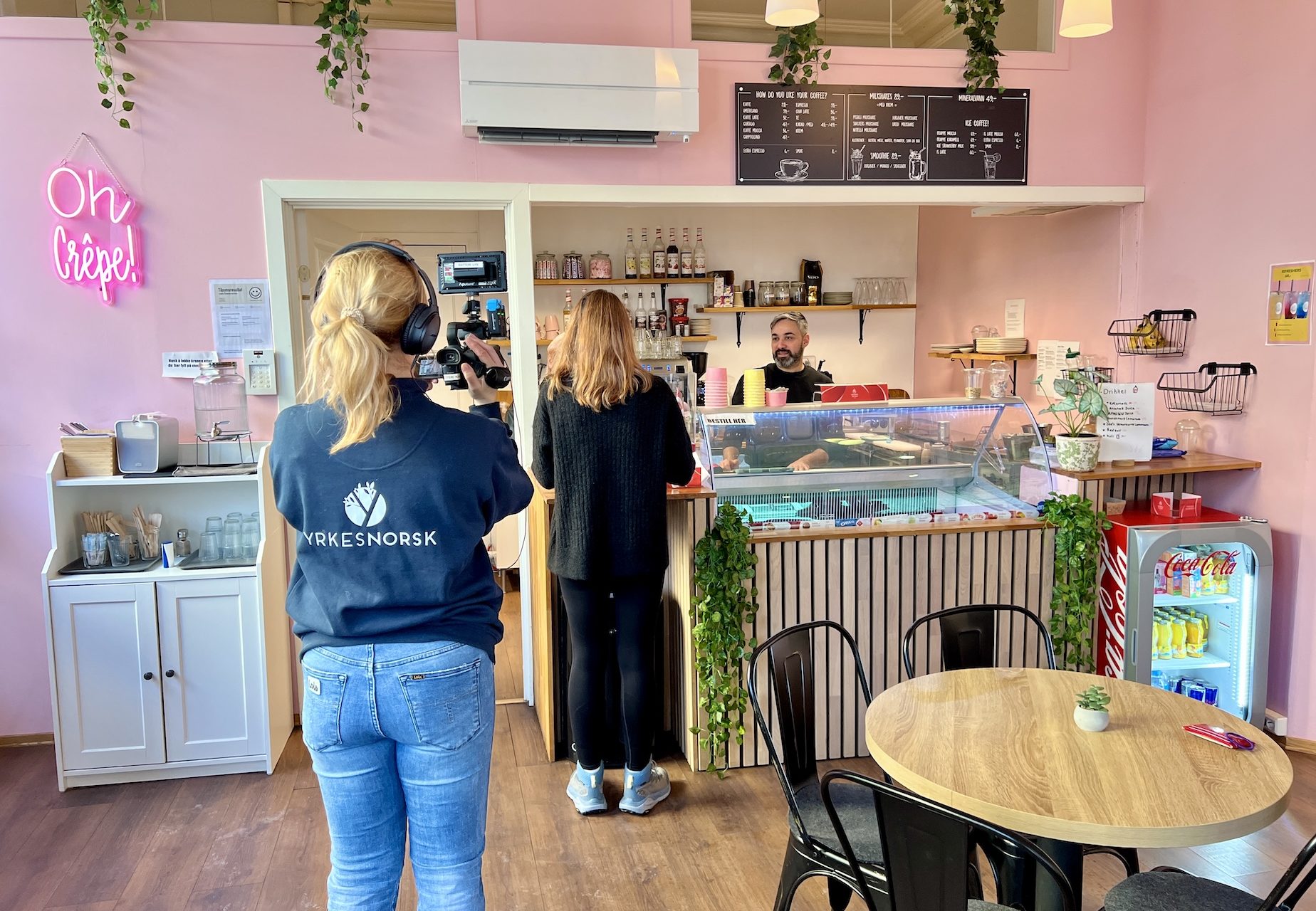Stine Bakkebø i Yrkesnorsk filmer en kundesituasjon på en kafé.